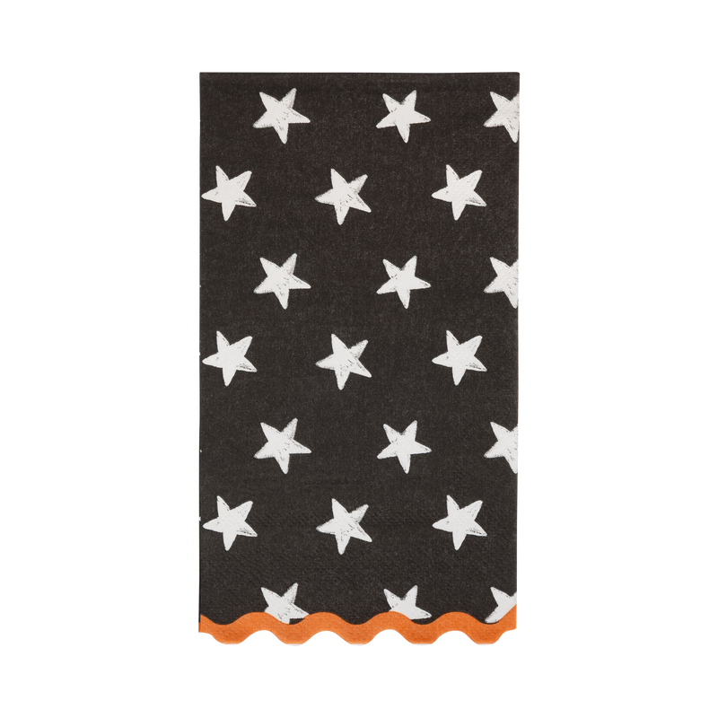 Black Halloween paper guest towel with white stars and an orange scalloped edge, shown folded on white
