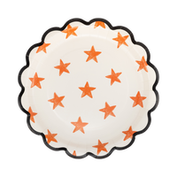 Cream round paper plate with a sketchy orange star pattern and black scalloped edge, front view.