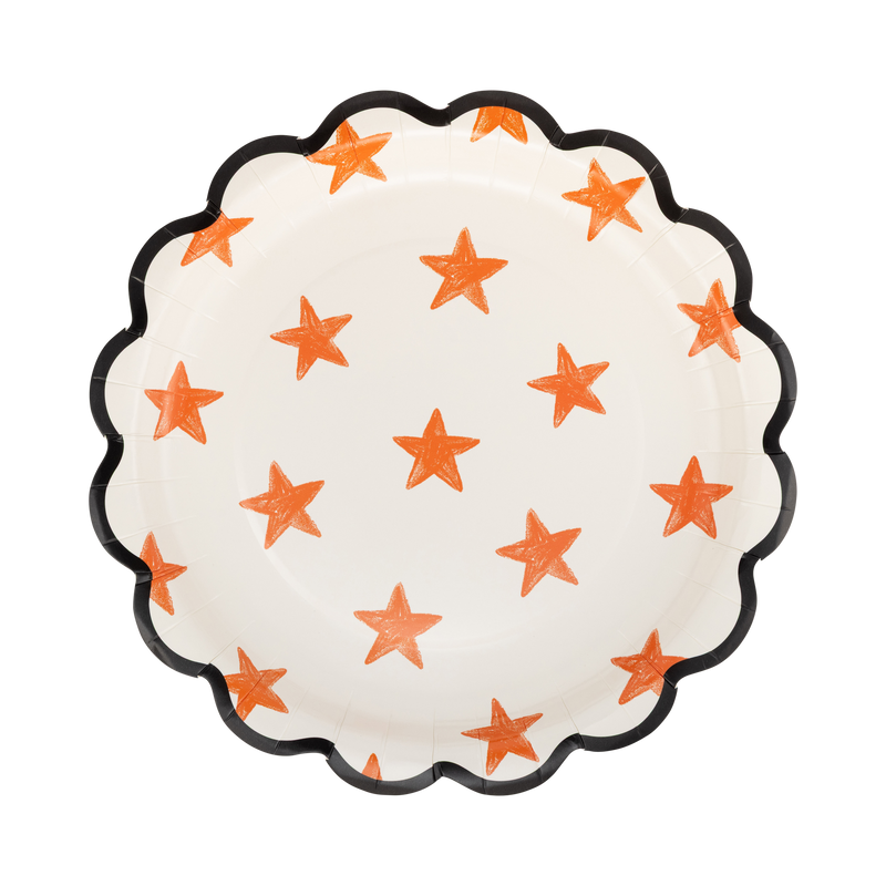 Cream round paper plate with a sketchy orange star pattern and black scalloped edge, front view.