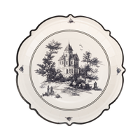 Decorative plate with black and white illustration of a haunted house and trees on a white background.