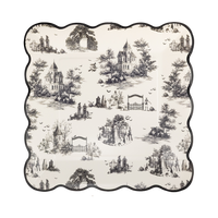 Decorative plate with black and white Halloween toile print design and a wavy edge, front view.
