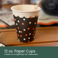 Moment & Co's Vintage Halloween Subscription Box - 12 oz. Paper Cups with white rim, black body, and orange and white polka dot design.