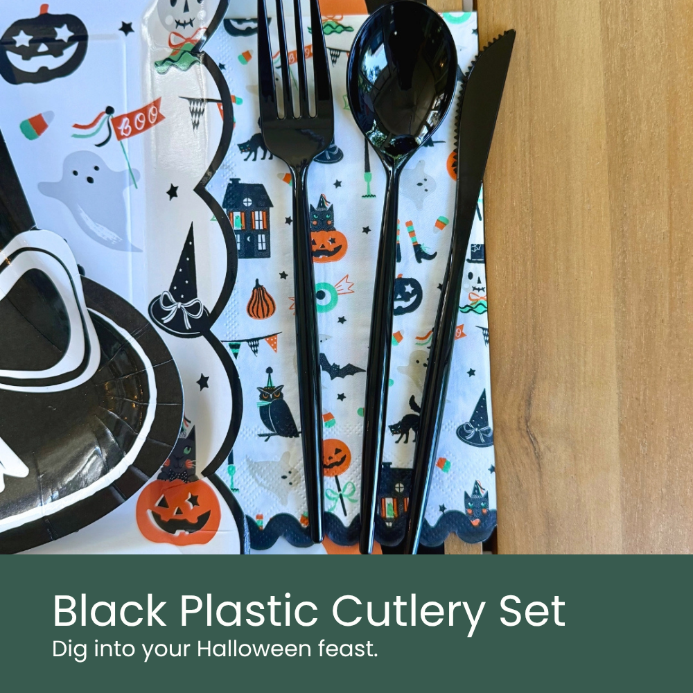Moment & Co's Vintage Halloween Subscription Box - Black Plastic Cutlery Set placed on top of Halloween icons dinner napkins.