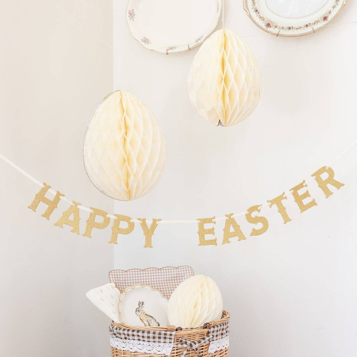 Cream honeycomb eggs hanging above a Happy Easter banner and styled spring basket display.