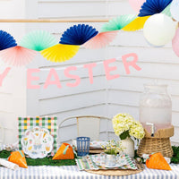 Happy Easter felt banner displayed over spring party table with decorations