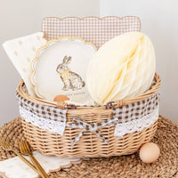Happy Easter bunny plate styled in a basket with coordinating Easter tableware and decor