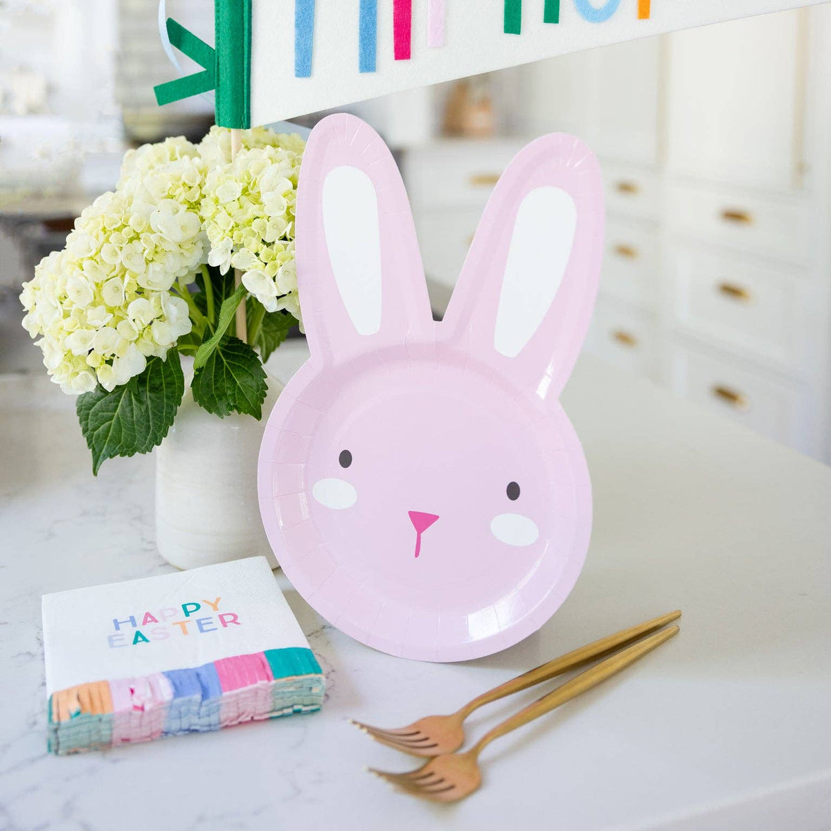 Happy Easter cocktail napkins on Easter table with other decor