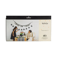 Back of package with lifestyle photo of the witch-hat banner over a “Trick or Treat” table, plus product info panel.