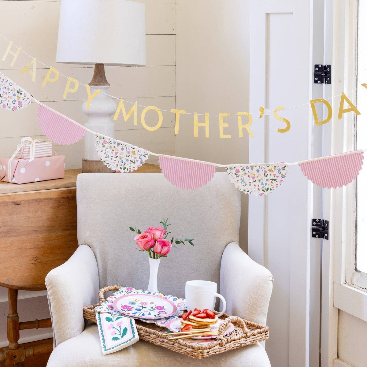 Happy Mother’s Day banner styled over chair with brunch setup