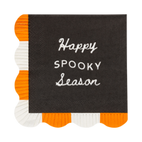 A single black cocktail napkin laid flat on a white background, "Happy Spooky Season" in cream lettering across the face, with two sides finished in an orange-and-white fringed scalloped border. Clean overhead product shot.