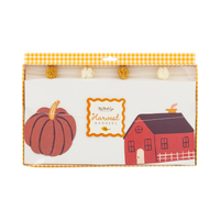 Packaged paper harvest icon with pumpkin and barn design and a fluffy pom pom on the cream thread.