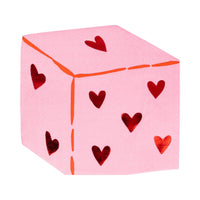 Pink dice-shaped napkin with red foil heart pips.