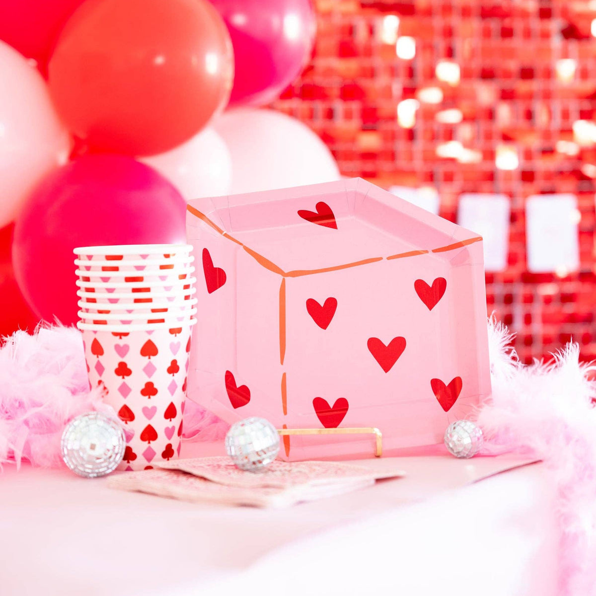 Heart dice plate displayed on a pink and red party table with coordinating cups.