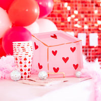 Heart dice plate displayed on a pink and red party table with coordinating cups.