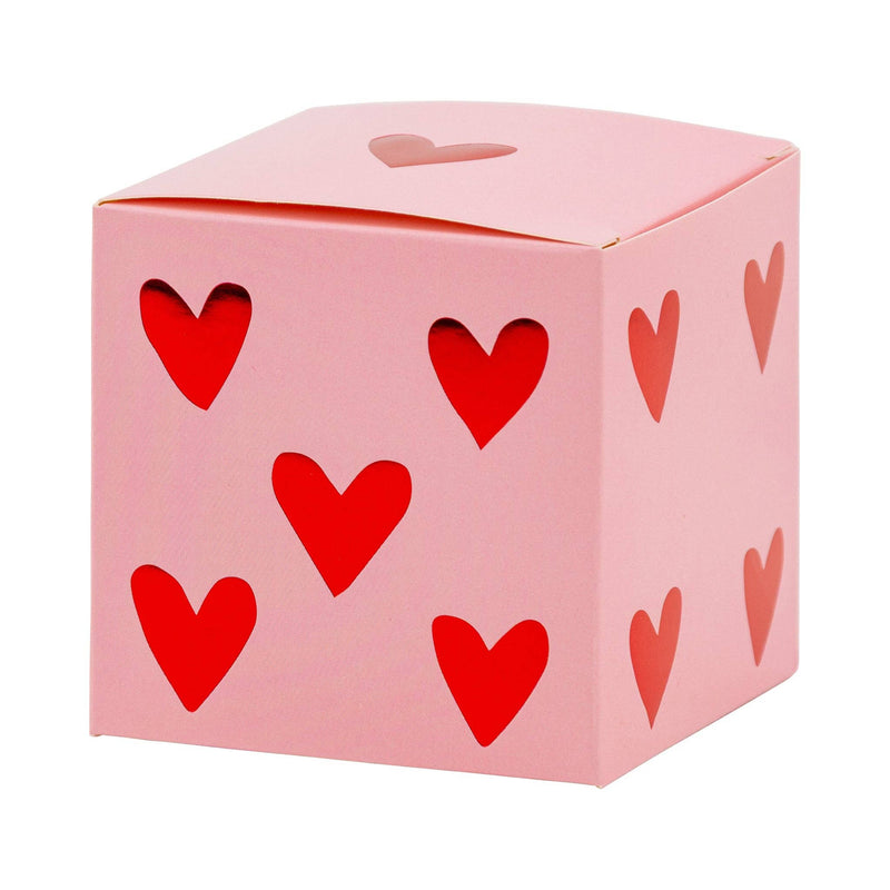 Pink paper heart dice treat box with red heart cutouts on each side