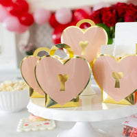 Group of heart lock treat boxes arranged on cake stand for Valentine party