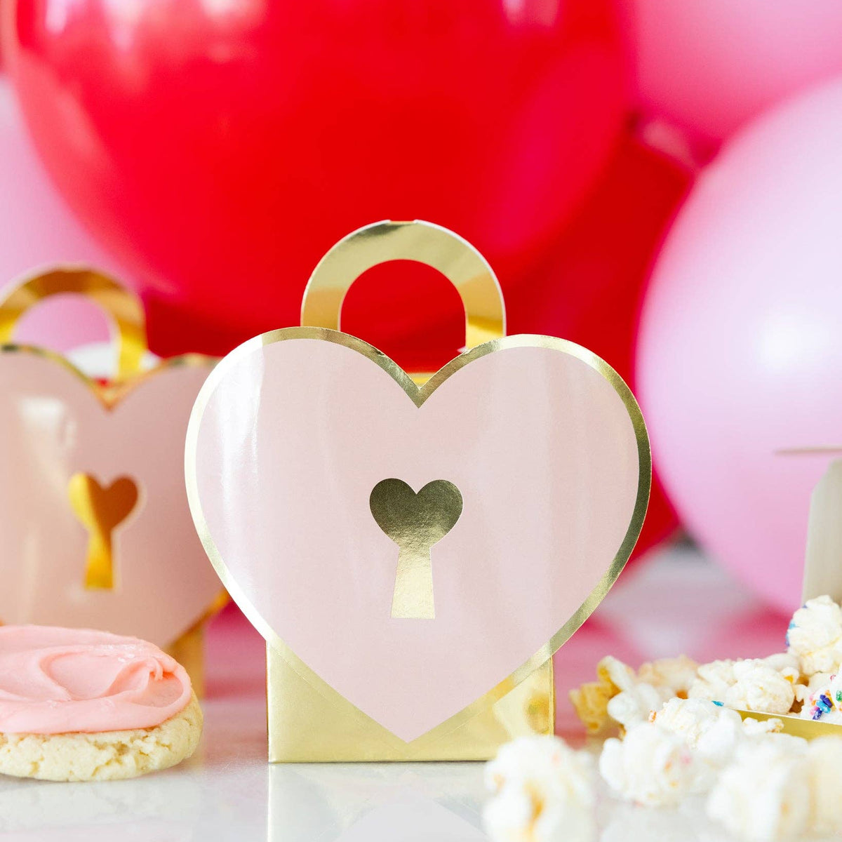 Heart lock treat box displayed on Valentine dessert table with sweets