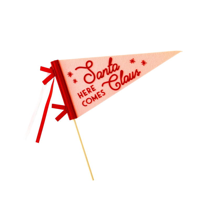 Close-up of Here Comes Santa Claus felt pennant in pink and red with ribbons.