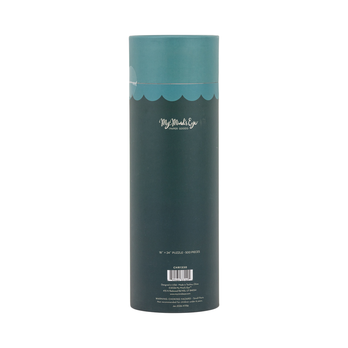 Home for Christmas puzzle tube styled with other holiday puzzles among greenery and gift boxes