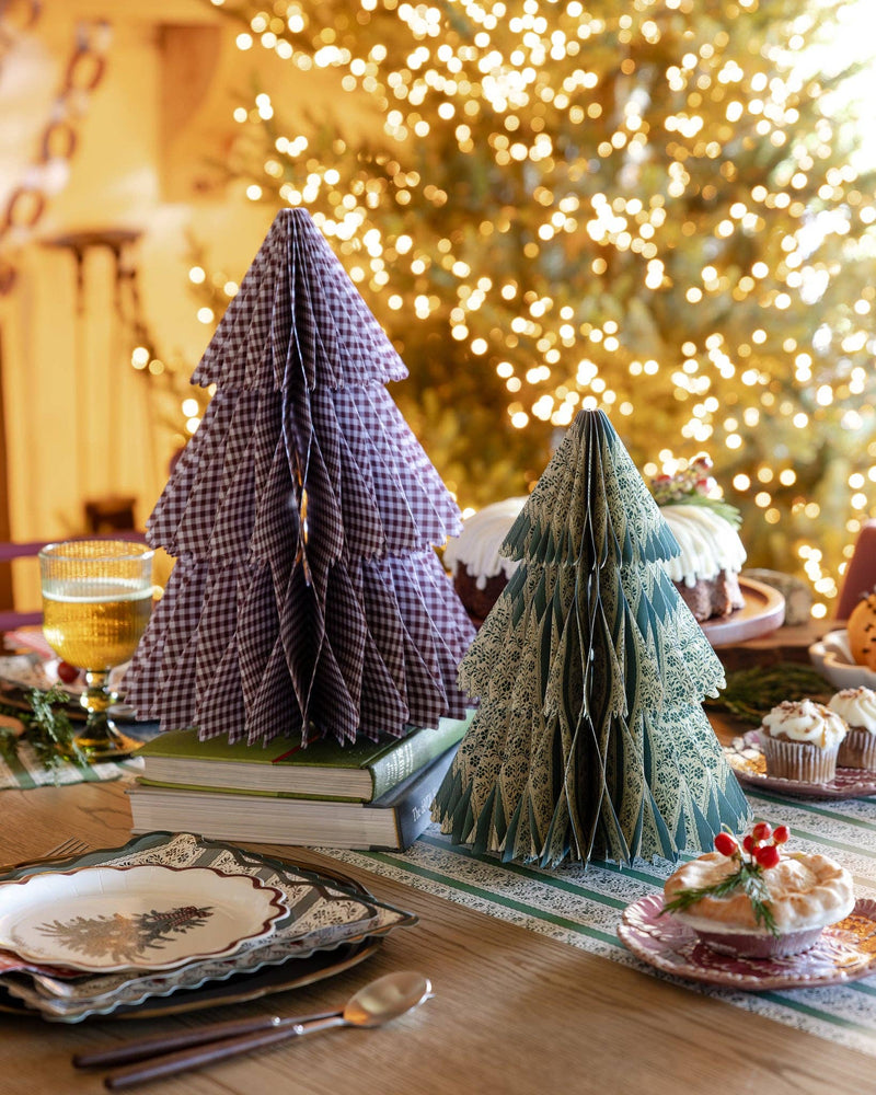 Gingham honeycomb trees as Christmas table centerpiece with lit tree behind