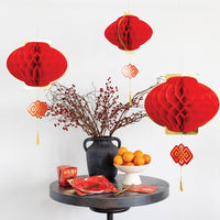 Honeycomb lantern decorations hanging above table with Lunar New Year decor
