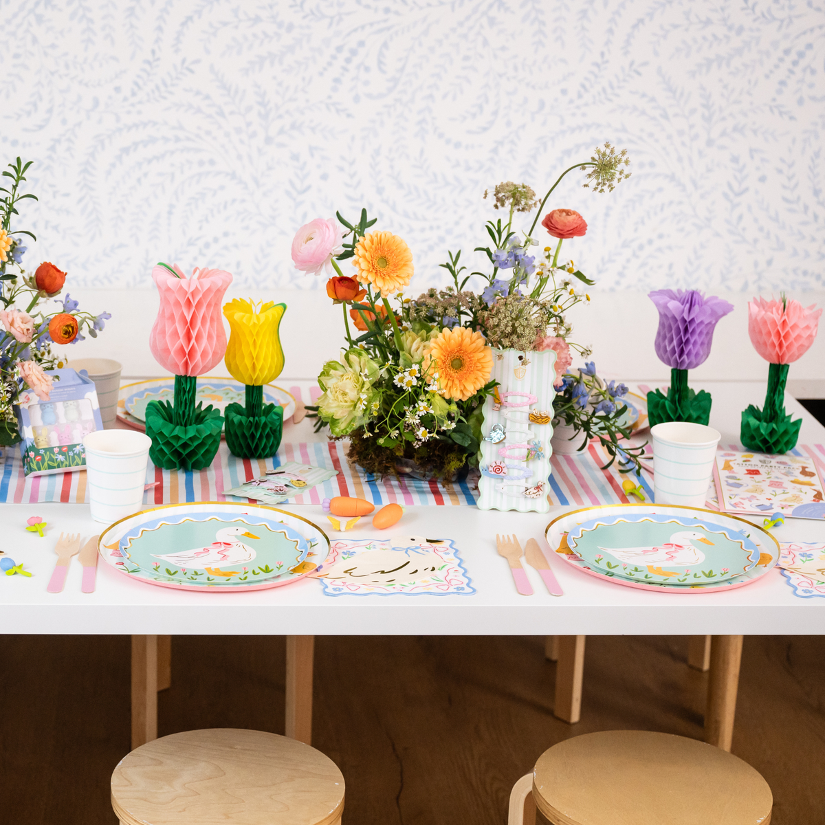 Honeycomb tulip decorations styled on a spring Easter table with flowers and plates