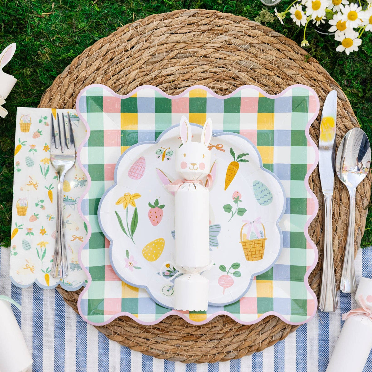 Easter place setting with pastel gingham plate layered under bunny plate on woven charger