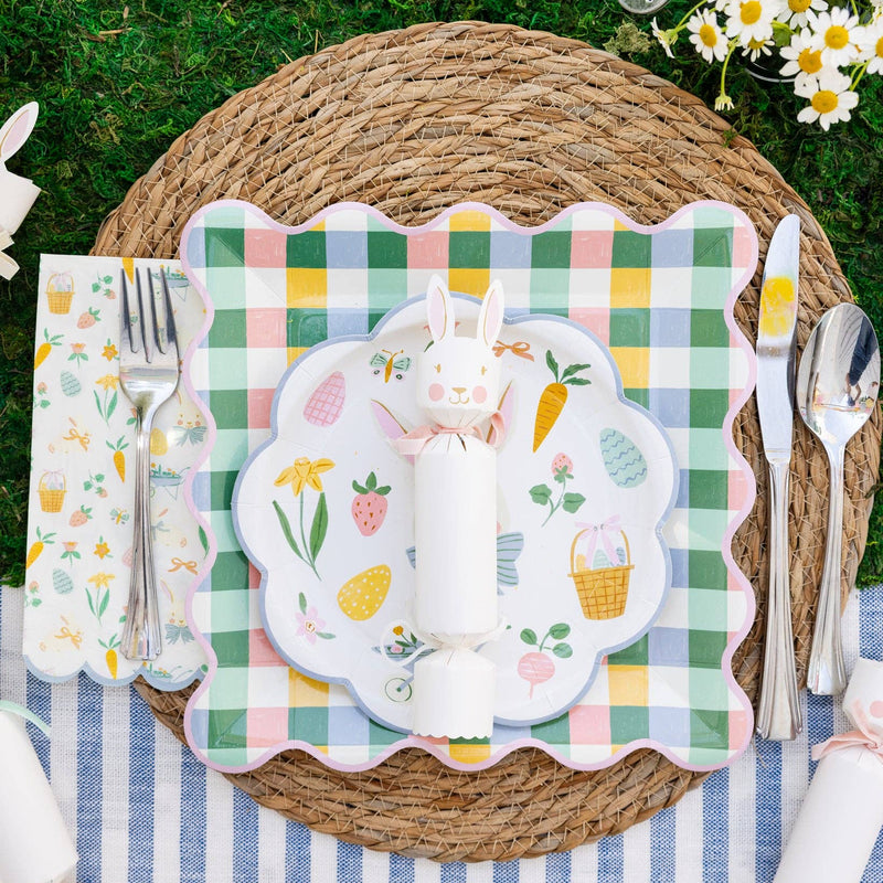Easter place setting with pastel gingham plate layered under bunny plate on woven charger