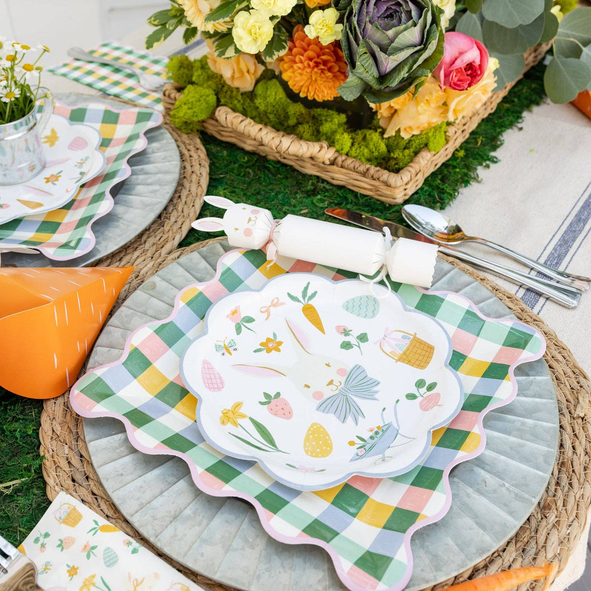 Spring tablescape featuring pastel gingham plate with layered Easter dinnerware and decorations