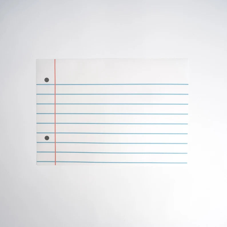 Isolated product image of a single loose‑leaf paper placemat on white background, highlighting blue lines and red margin.