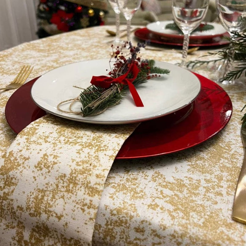 Gold and White tablecloth on a Christmas table setting.