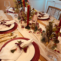 Gold and White tablecloth on a Christmas table setting.