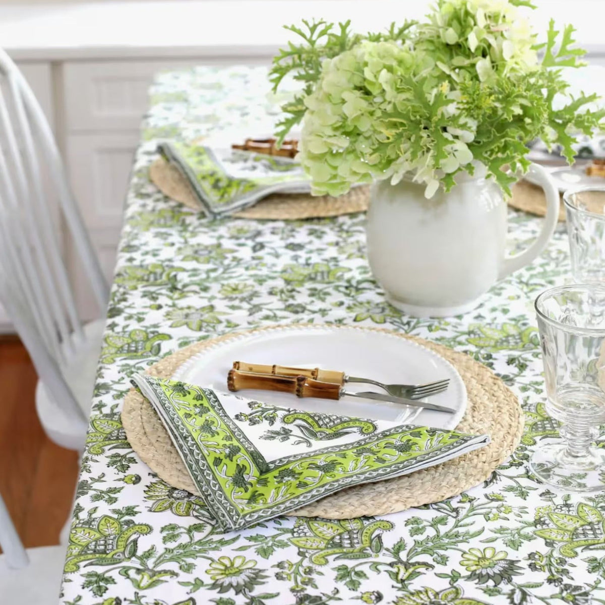 Discover the perfect backdrop for your summer celebrations with our Green Floral Tablecloth. Measuring 60"x 92", this tablecloth combines practicality with style, making it an essential addition to your garden party decor. Made from soft, durable cotton with a vibrant green and white block print, it’s not just a tablecloth—it’s a part of the party. Your guests will love this eye-catching floral tablecloth.