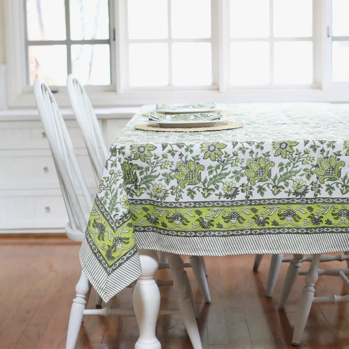 Discover the perfect backdrop for your summer celebrations with our Green Floral Tablecloth. Measuring 60"x 92", this tablecloth combines practicality with style, making it an essential addition to your garden party decor. Made from soft, durable cotton with a vibrant green and white block print, it’s not just a tablecloth—it’s a part of the party. Your guests will love this eye-catching floral tablecloth.