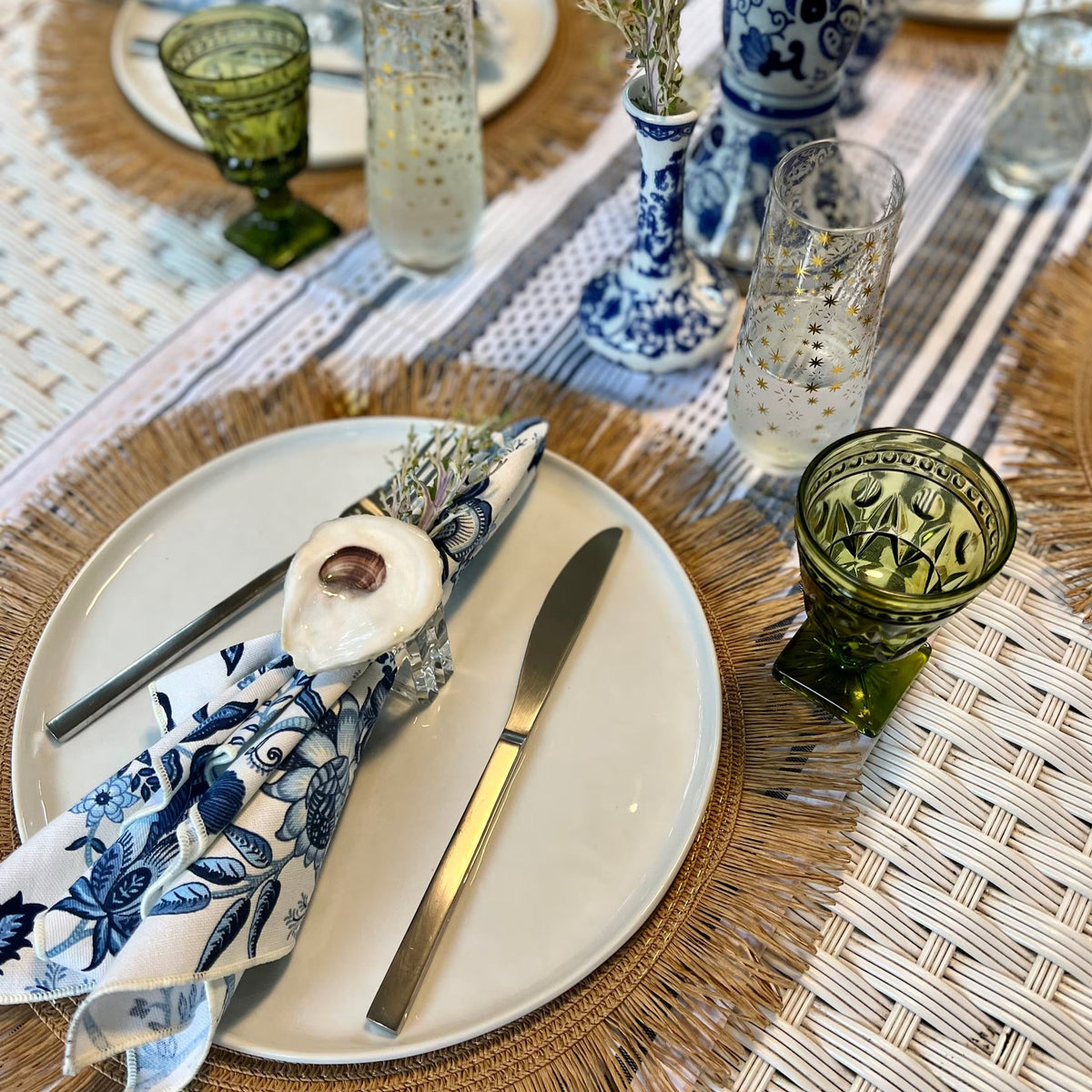 Bring the beach to your table settings with our Oyster Shell Napkin Rings. These napkin rings are the perfect addition to your tropical table decor, featuring real oyster shells finished in a shiny epoxy and mounted to acrylic rings with convenient velcro. Ideal for those who love a bit of the coastal vibe in their dining decor.