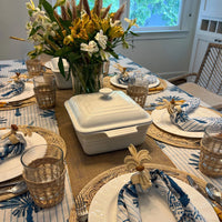 Escape to the tropics at every meal with our woven Palm Tree Napkin Rings. Crafted to complement your tropical table decor, these napkin rings feature natural-colored palm trees with brown coconuts, adding a coastal touch to your table. Perfect for hosting a luau or simply spicing up dinner, these palm tree napkin rings offer an instant vacation vibe.