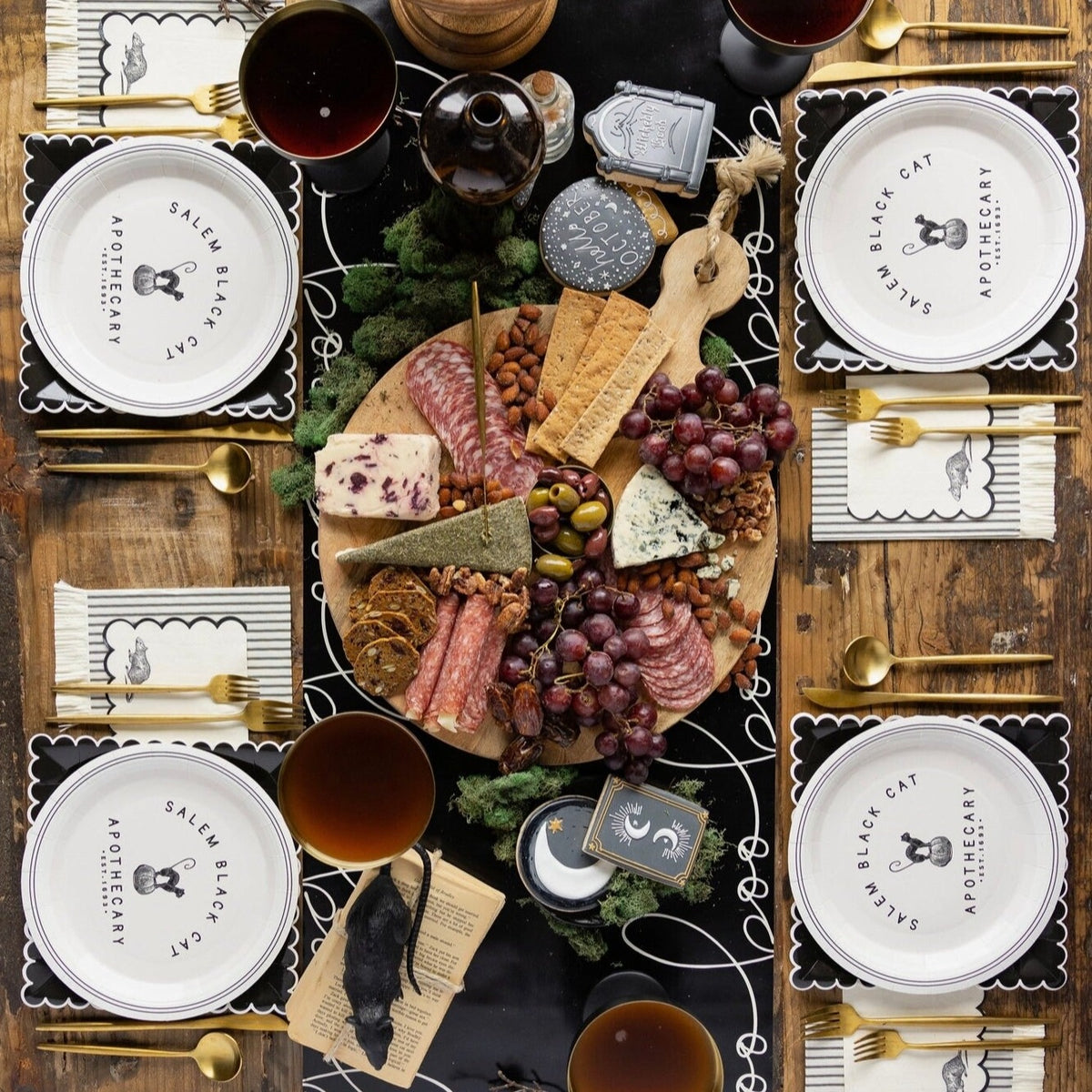Black paper table runner with white wording boo - perfect for a halloween table. 