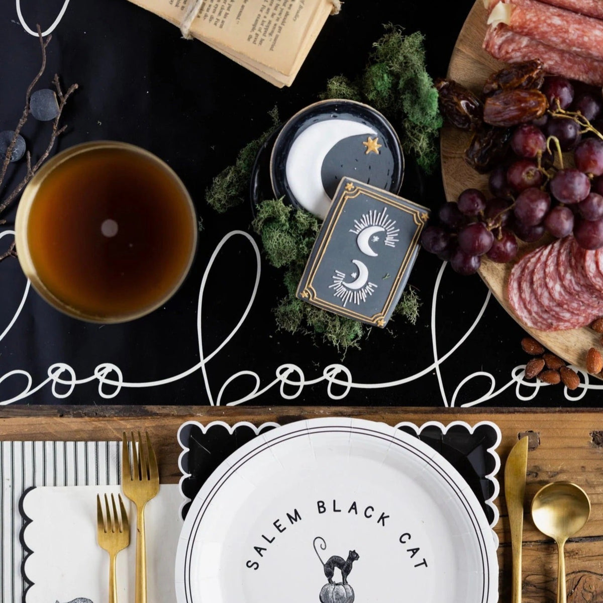 Black paper table runner with white wording boo - perfect for a halloween table. 