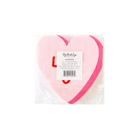 Red and pink paper cocktail napkins shaped like a heart and the words love u; perfect for a anniversary party, bachelorette  or an engagement party