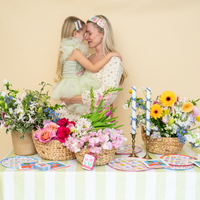 Mother and daughter at a spring table with In Bloom floral plates and garden party setup