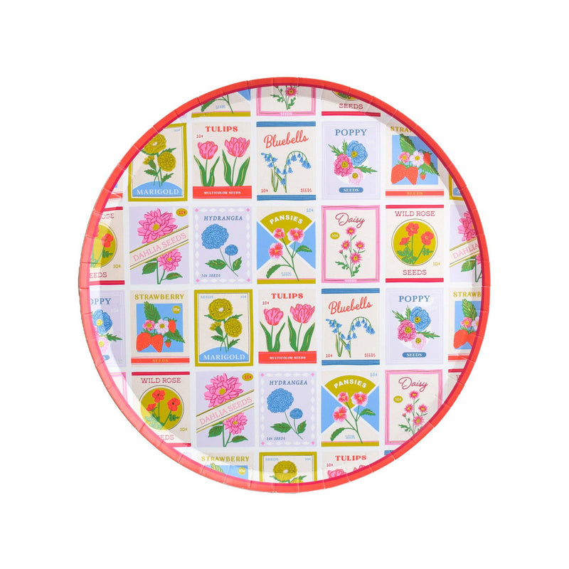 Round dessert plate with colorful vintage seed packet floral designs and coral rim on white background