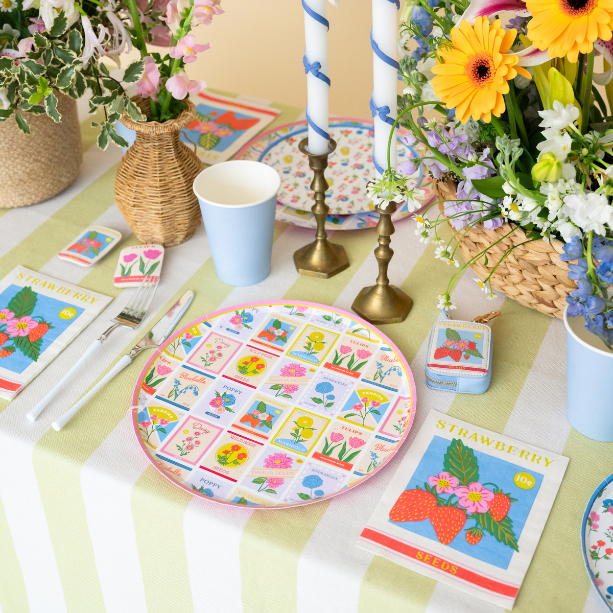 In Bloom seed packet dinner plate styled on a spring table with flowers and candles