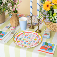 In Bloom strawberry napkins styled on spring table with floral plates and candles