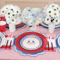 Multiple 8.5-inch Party Plates arranged on a striped tablecloth for a Preppy Patriotic Table Setting.