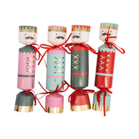 Isolated view of four Nutcracker Crackers showing the pink, mint, red, and green designs and gold foil accents.