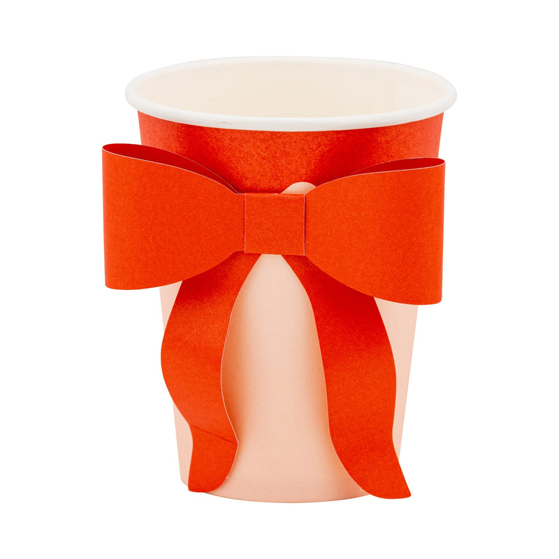 Isolated image of a single assembled bow cup showing the red bow attached to the pink cup body.
