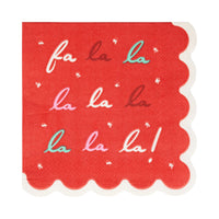 Red paper cocktail napkin with 'fa la la la la la la!' text on a white background
