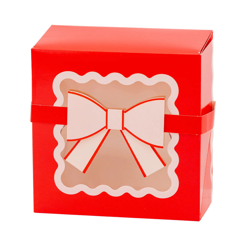 Isolated view of a single red box showing the scalloped window cutout and white paper bow band design.