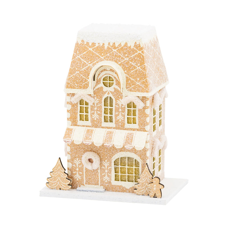 Isolated view of the tall gingerbread house putz house (Gingerbread Shop) with window cutouts and heavy glitter.