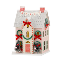 Close-up of the lighted Christmas village house featuring a "MERRY" banner and red bows, perfect for retro Christmas decor.